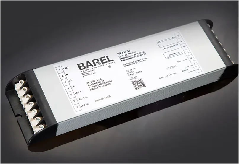 Close-up of a silver BAREL emergency inverter with a label displaying model HFXE T8 BG1 and wiring instructions.
