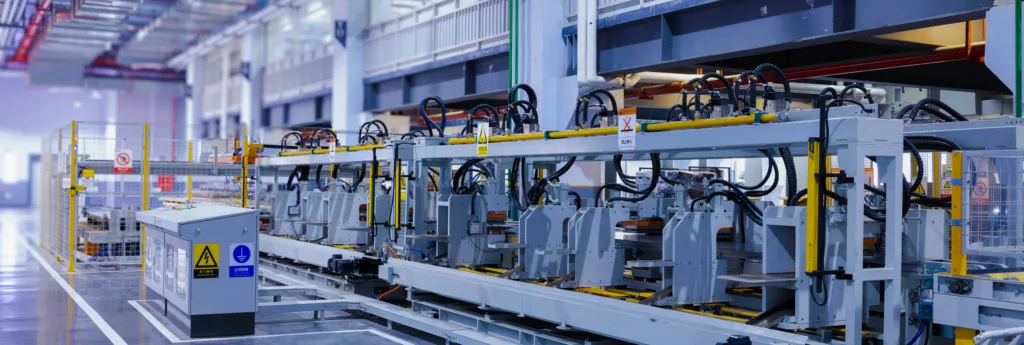 Automated manufacturing equipment on a production line inside a clean, modern industrial facility.